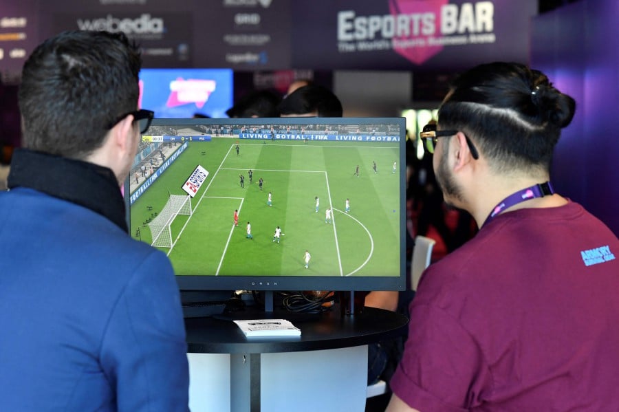 Visitors playing on EA Vancouver video game developer's football simulation video game FIFA 19 at the eSports Bar trade fair in Cannes, southern France. - The 2023 edition of Fifa, the leader of soccer simulation video games, will be out on September 30, 2022, as it is developed each year by the american editor Electronic Arts since 1993. -AFP file pic
