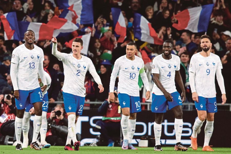 France's defender Benjamin Pavard (second from left) celebrates with teammates after scoring the opening goal of the UEFA Euro 2024 group B qualification football match between Republic of Ireland and France at Aviva Stadium in Dublin, Ireland. (Photo by Paul Faith / AFP)