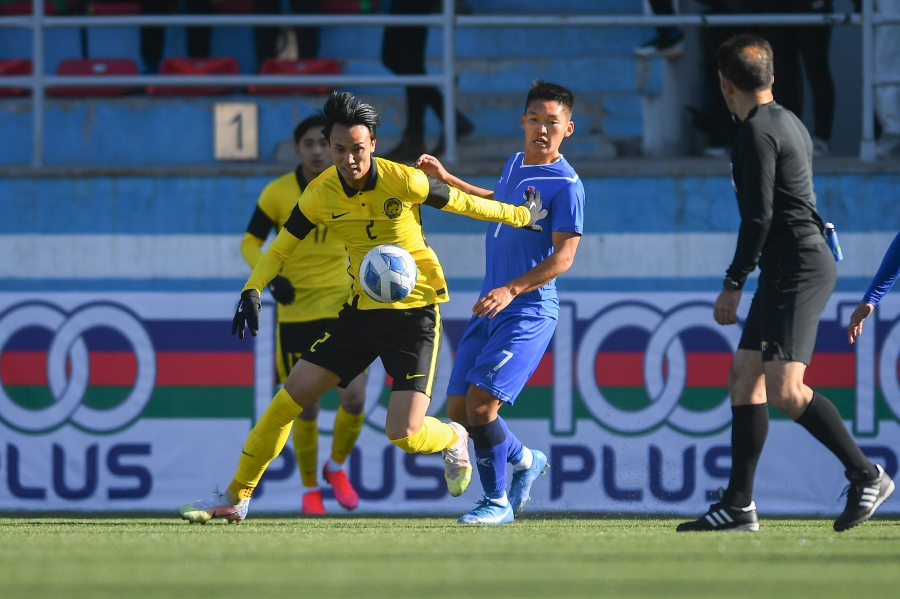 Malaysia’s Quentin Cheng dribbles the ball in an AFC Under-23 qualifier against Mongolia in Ulaanbaatar yesterday. -Pic courtesy of AFC