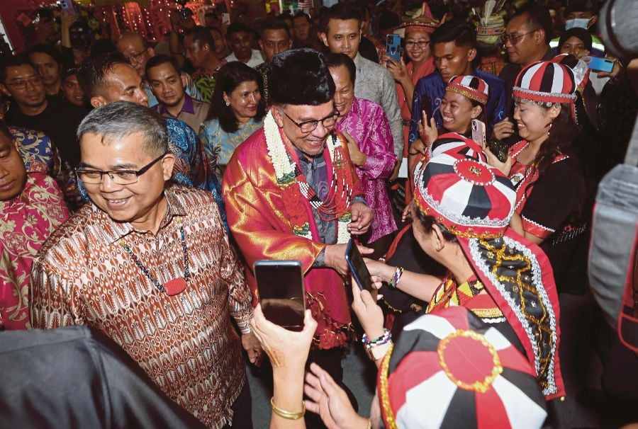 Prime Minister Datuk Seri Anwar Ibrahim greeting people at the national-level Unity Week 2024 celebration in Johor Baru on Saturday. With him is National Unity Minister Datuk Aaron Ago Dagang (left). BERNAMA PIC 