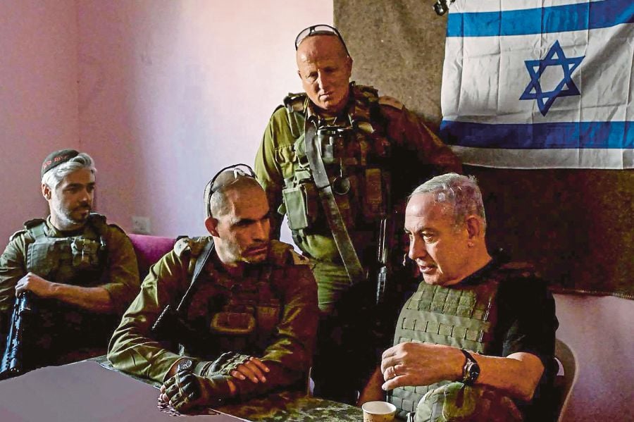 Israeli Prime Minister Benjamin Netanyahu having a chat with soldiers in Gaza on Sunday. AFP/ISRAELI PMO 