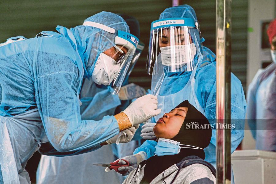 A medical worker performing a swab test in Kuala Lumpur in April. In 2020, Malaysians demonstrated to themselves and to the world what a nation can achieve when a society stands together. FILE PIC 