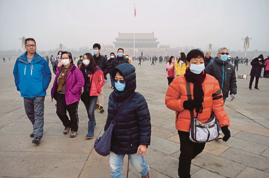 People wearing masks at Tiananmen Square in Beijing. Carbon trading is something that even the developed West struggles to put in place, but China is paving the way. AFP PIC 