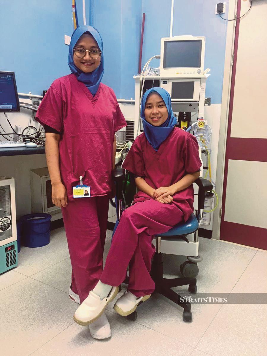 Dr Farah Shaheera Roslan (right) with Dr Fadzlien Zahari, who assisted the search for disposable hijab. 