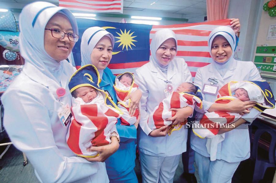 Nurses holding babies born on National Day at Melaka Hospital in August. -NSTP/File pic