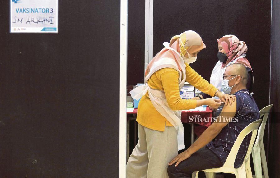 A man receiving a booster shot of the Covid-19 vaccine in Kuala Terengganu last year. Only 1.9 per cent of the Malaysian population have received their second booster dose. - NSTP file pic