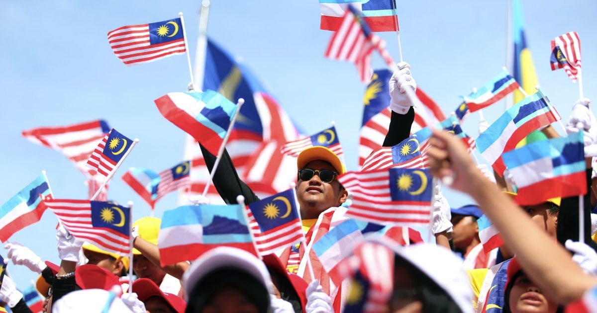 Malaysians celebrate Merdeka  on Mt Kinabalu New Straits 