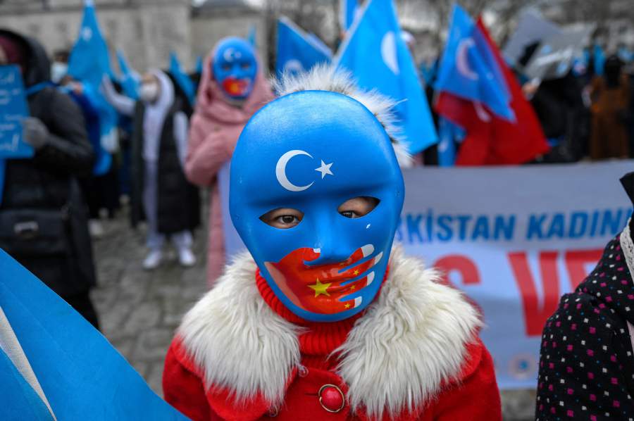 A children from the Uyghur community living in Turkey wears a mask during a protest against the visit of China's Foreign Minister to Turkey, in Istanbul on March 25, 2021. -AFP PIC
