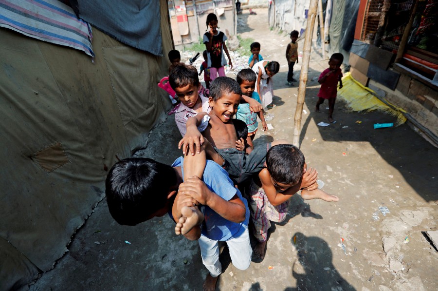 Children from the Rohingya community play outside their shacks in a camp in New Delhi, India. -REUTERS PIC