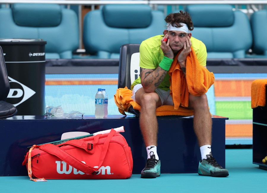 Thiago Seyboth Wild of Brazil looks on as the court is blown dry due to rain before his match against Taylor Fritz of the Miami Open at Hard Rock Stadium in Miami Gardens, Florida. --AFP PIC