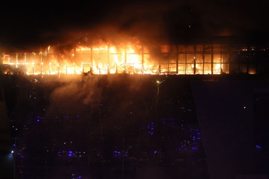 A view shows the burning Crocus City Hall concert hall following the shooting incident in Krasnogorsk, outside Moscow. - AFP PIC