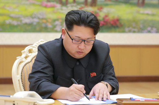 (File pix) This picture taken by North Korea's official Korean Central News Agency (KCNA) on January 3, 2016 and released on January 7 shows North Korean leader Kim Jong-Un signing a document for a hydrogen bomb test in Pyongyang. North Korea announced on January 6 it had successfully carried out its first hydrogen bomb test, a development that, if confirmed, would marking a stunning step forward in its nuclear development. AFP Photo