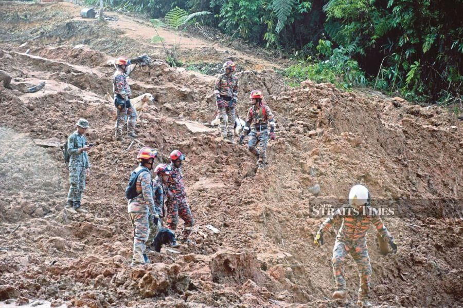 A file pic dated Dec 21, 2022, shows firemen conducting a search and rescue missing to locate victims following the landslide at the Father's Organic Farm along Jalan Genting-Batang Kali. - Pic courtesy of Fire and Rescue Dept. 