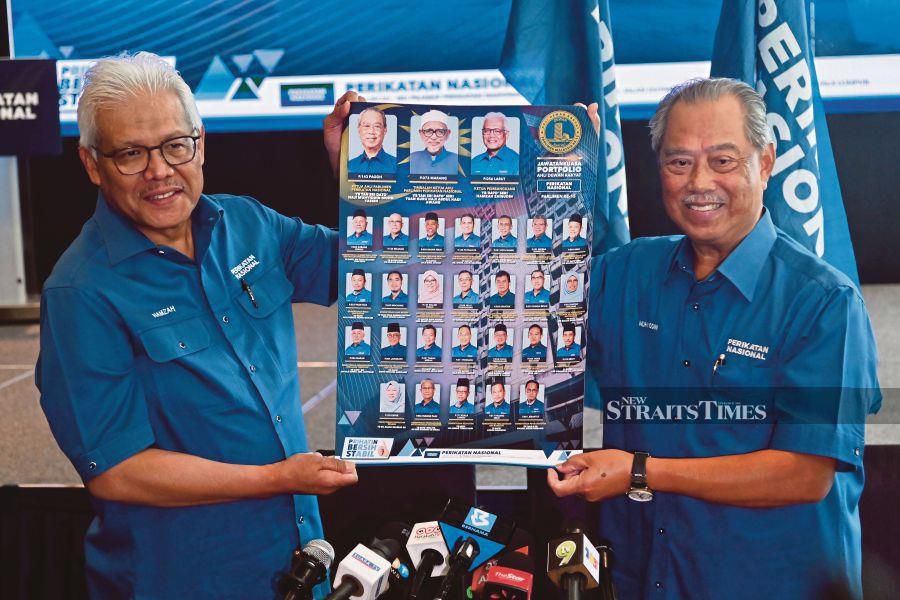 A file pic showing Parti Pribumi Bersatu Malaysia (Bersatu) president Tan Sri Muhyiddin Yassin (right) with the party’s secretary-general Datuk Seri Hamzah Zainudin, unveiling the Perikatan Nasional’s members of parliament on Feb 2, 2023 in Kuala Lumpur. - NSTP file pic