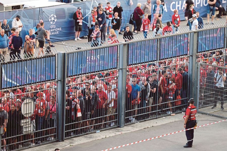  In this file photo taken on May 28, 2022 Liverpool fans stand outside unable to get in in time leading to the match being delayed prior to the UEFA Champions League final football match between Liverpool and Real Madrid at the Stade de France in Saint-Denis, north of Paris. - AFP PIC