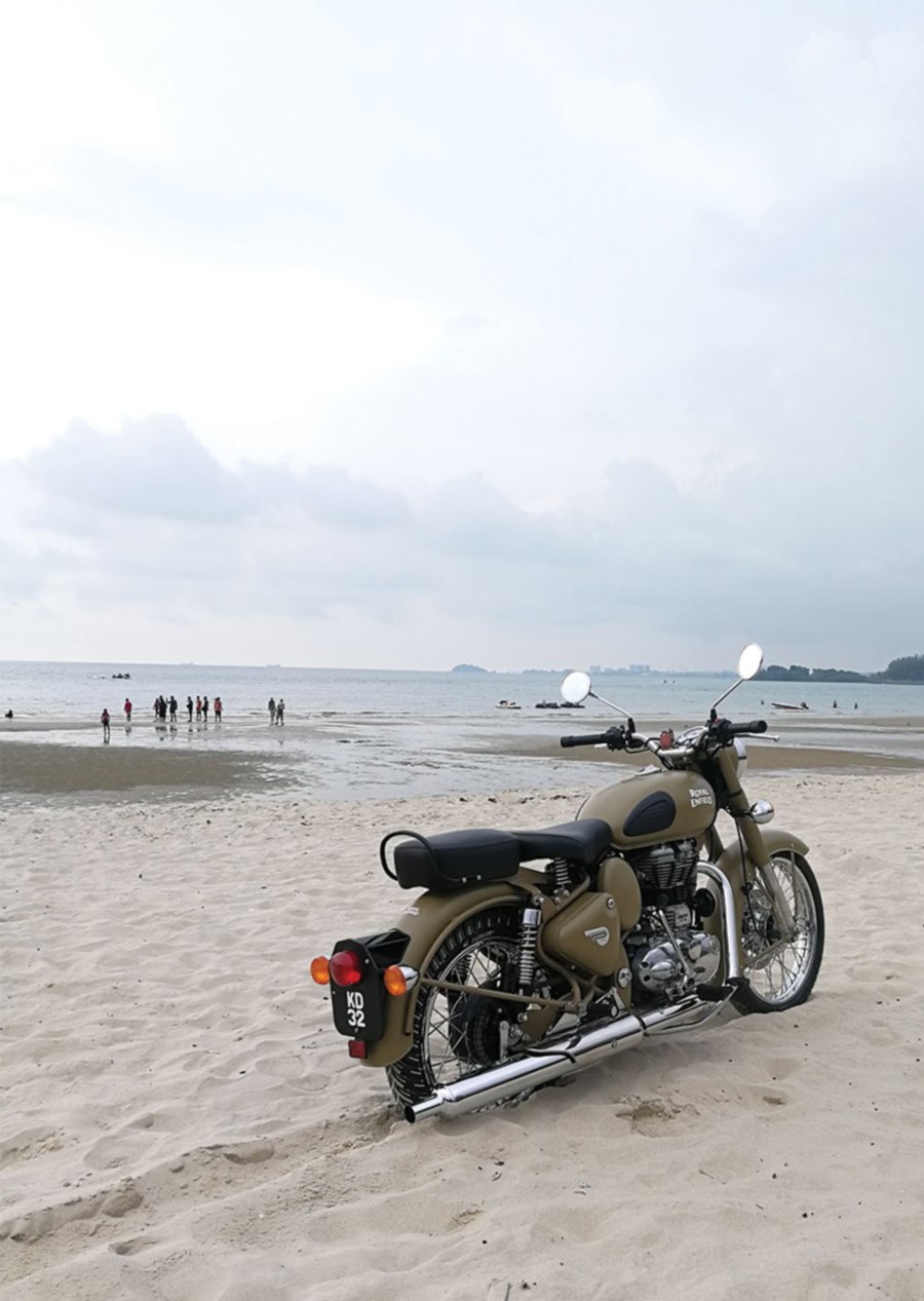 A Royal Enfield Classic Desert Storm invading the beach at Port Dickson.