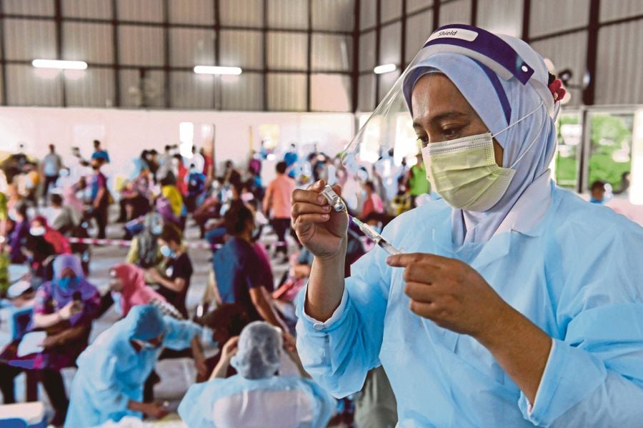 A nurse in Sabah preparing a syringe of Covid-19 vaccine in 2021. Countries negotiating a global pandemic agreement are deadlocked over issues like resource sharing. FILE PIC