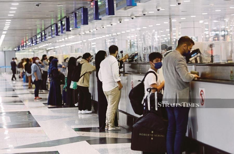 A general view of passengers at the Immigration counters at the Kuala Lumpur International Airport. - NSTP file pic