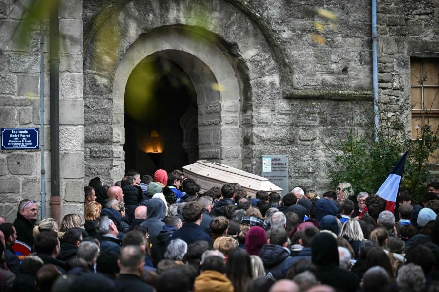 The coffin of Thomas, a teenager who passed away on November 19, 2023 in Crepol after being wounded with a knife during a ball in the small village in the Drome region, is carried during his funerals at the entrance of the Collegiate church of Saint-Donat-sur-l'Herbasse, south-eastern France, on November 24, 2023. - AFP PIC