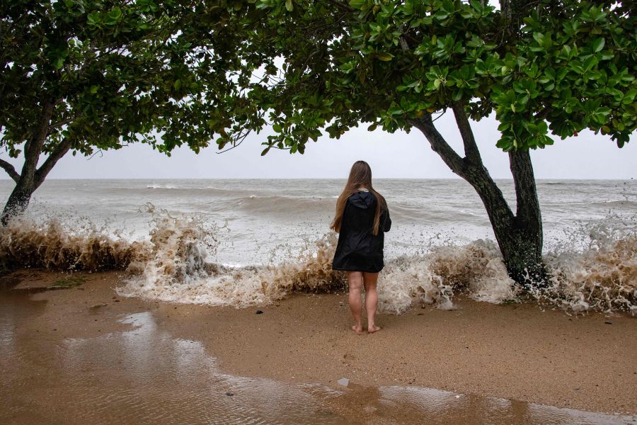 Holloways Beach resident Lisa Methven watches the storm across the Coral Sea as Cyclone Jasper approaches landfall in Cairns in far north Queensland. - AFP PIC