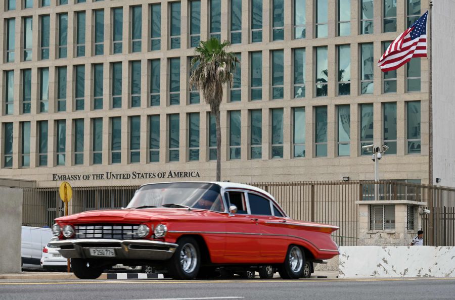 A car drives past the US embassy in Havana. - AFP PIC