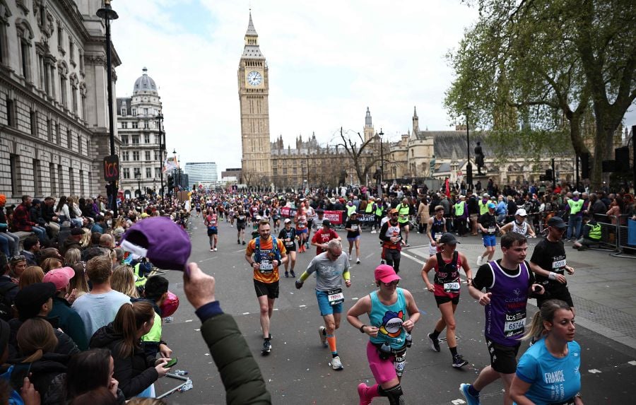 Fun runners compete near the Houses of Parliament during the 2024 London Marathon in central London on April 21, 2024. - AFP PIC