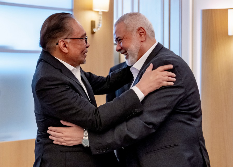 This May 14 picture shows Prime Minister Datuk Seri Anwar Ibrahim meeting with Hamas leader Ismail Haniyeh in Doha. - BERNAMA PIC