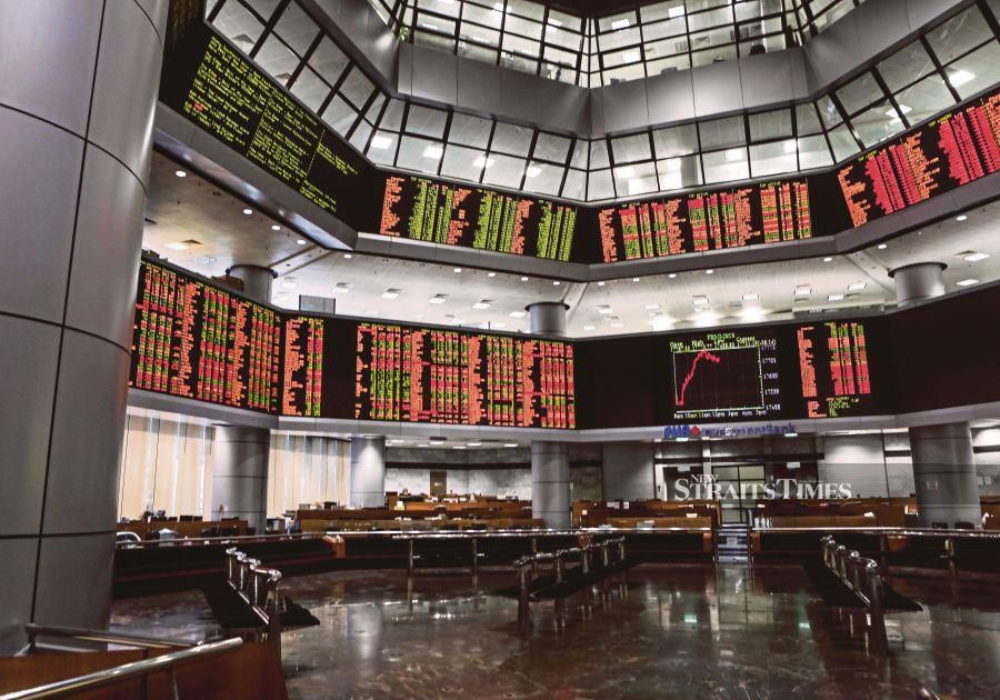 Bursa Malaysia ended lower at midday in tight trading range in tandem with weaker regional markets as investors took profits awaiting key economic data from several countries. - STR/HAZREEN MOHAMAD