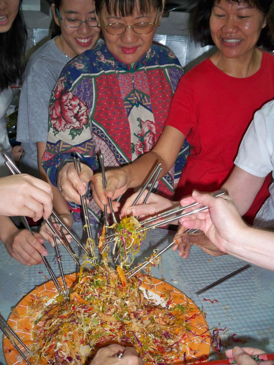A family celebrating Chinese New Year with Yee Sang. - File pic credit (Wikipedia)