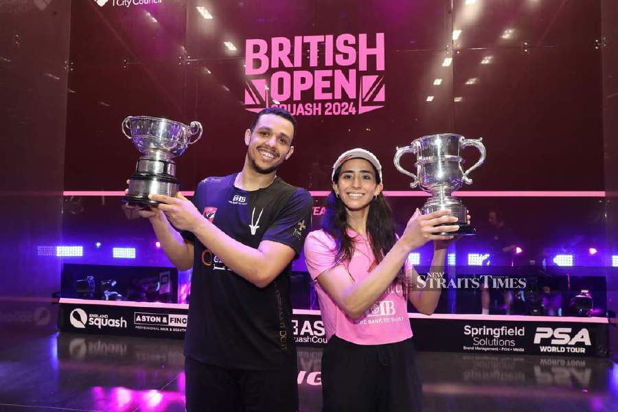 Mostafa Asal (left) and Nouran Gohar with their British Open trophies in Birmingham on Sunday. PIC FROM PSA WORLD TOUR