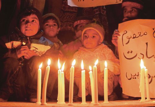  Supporters of Pakistan Tehrik-e-Insaf (PTI) light candles to pray for the victims who were killed in an attack at the Army run school in Peshawar, during a memorial ceremony in Hyderabad Pakistan. EPA