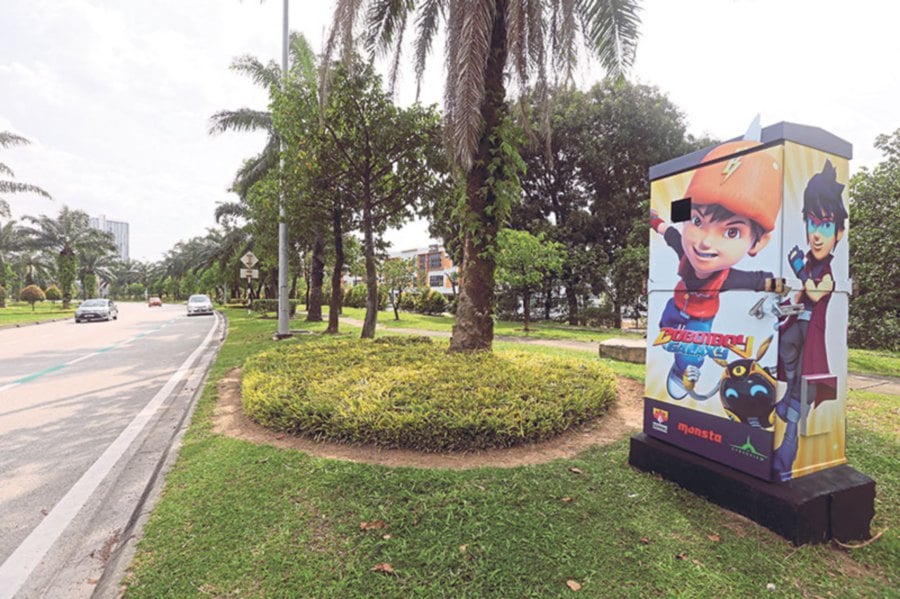 A Boboiboy illustration on an electricity supply box brightens up the surroundings.