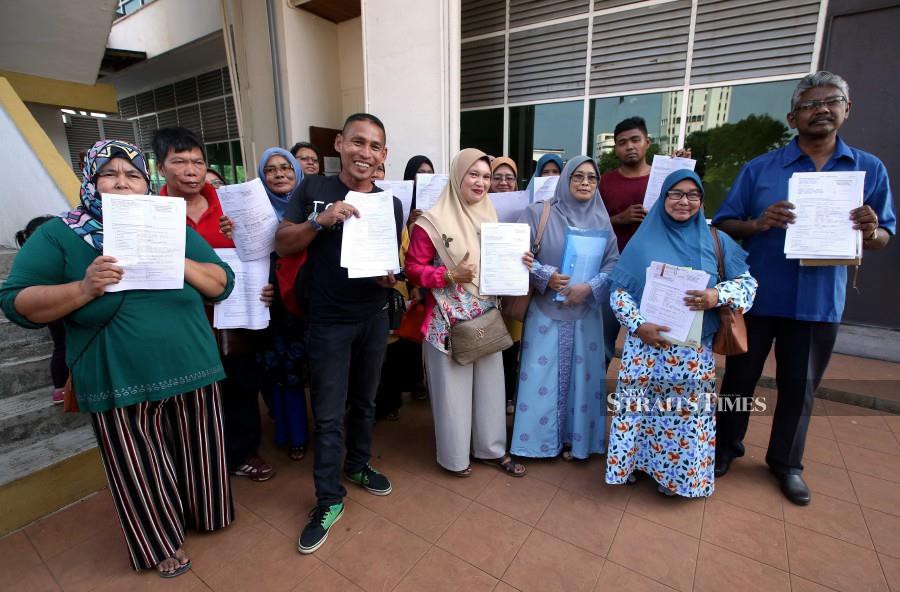 Workers showing their complaint forms after a meeting with Pahang Industrial Relations Department in Kuantan. - NSTP/Muhd Asyraf Sawal.