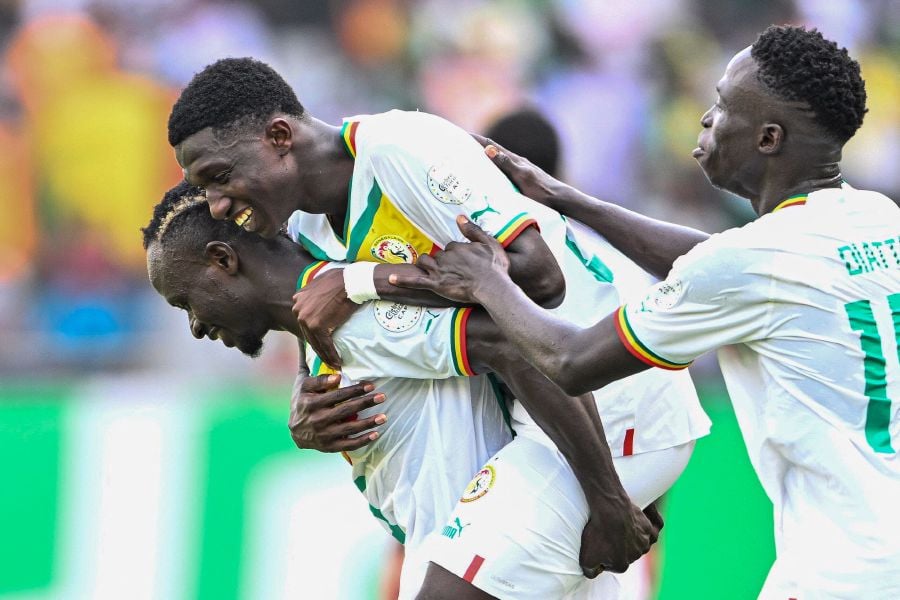 Senegal's midfielder #25 Lamine Camara (C) celebrates with teammates after scoring his team's third goal during the Africa Cup of Nations (CAN) 2024 group C football match between Senegal and Gambia on January 15, 2024.- AFP pic