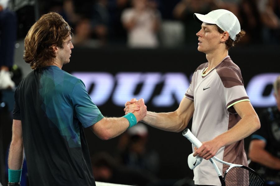 Italy's Jannik Sinner (R) shakes hands with Russia's Andrey Rublev after their men's singles quarter-final match on day 10 of the Australian Open tennis tournament in Melbourne on January 24, 2024. - AFP pic