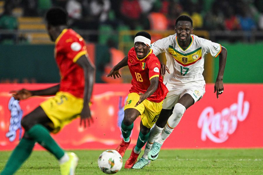 Guinea's midfielder #18 Aguibou Camara (C) fights for the ball with Senegal's midfielder #17 Pape Matar Sarr (R) during the Africa Cup of Nations (CAN) 2024 group C football match between Guinea and Senegal on January 23, 2024. - AFP pic
