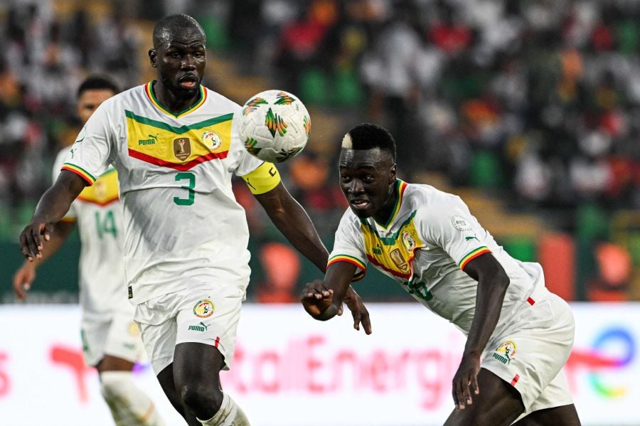Senegal's midfielder #26 Pape Gueye (R) heads the ball next to Senegal's defender #3 Kalidou Koulibaly during the Africa Cup of Nations (CAN) 2024 group C football match between Guinea and Senegal at Stade Charles Konan Banny in Yamoussoukro on January 23, 2024. - AFP pic