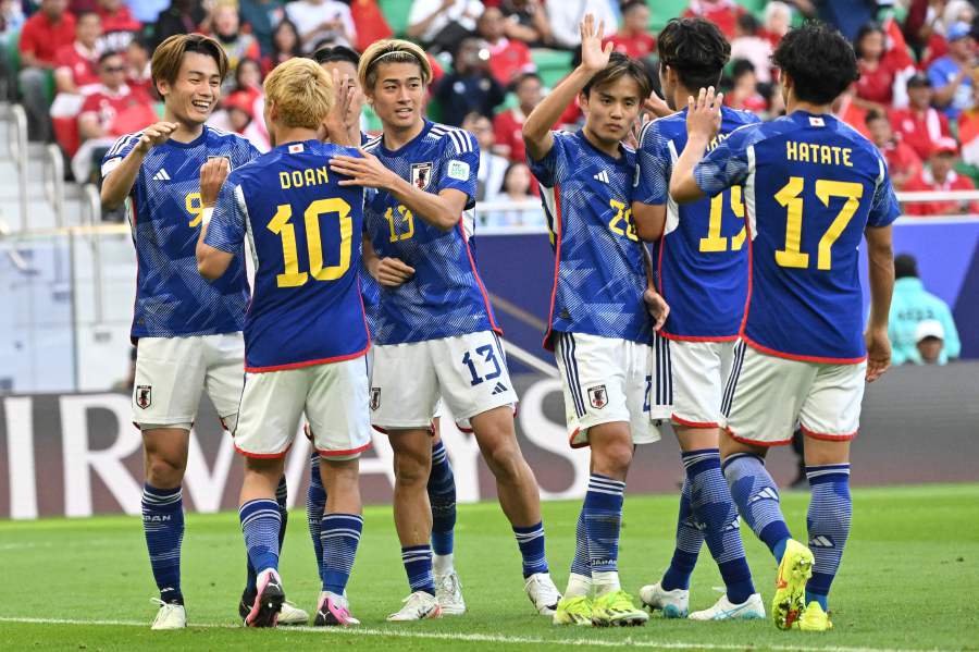 Japan's players celebrate after their second goal during the Qatar 2023 AFC Asian Cup Group D football match between Japan and Indonesia on January 24, 2024. - AFP pic