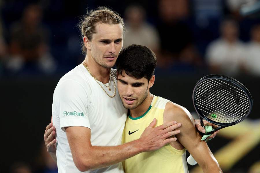 Germany's Alexander Zverev (L) embraces Spain's Carlos Alcaraz after their men's singles quarter-final match on day 11 of the Australian Open tennis tournament in Melbourne on January 25, 2024. - AFP pic