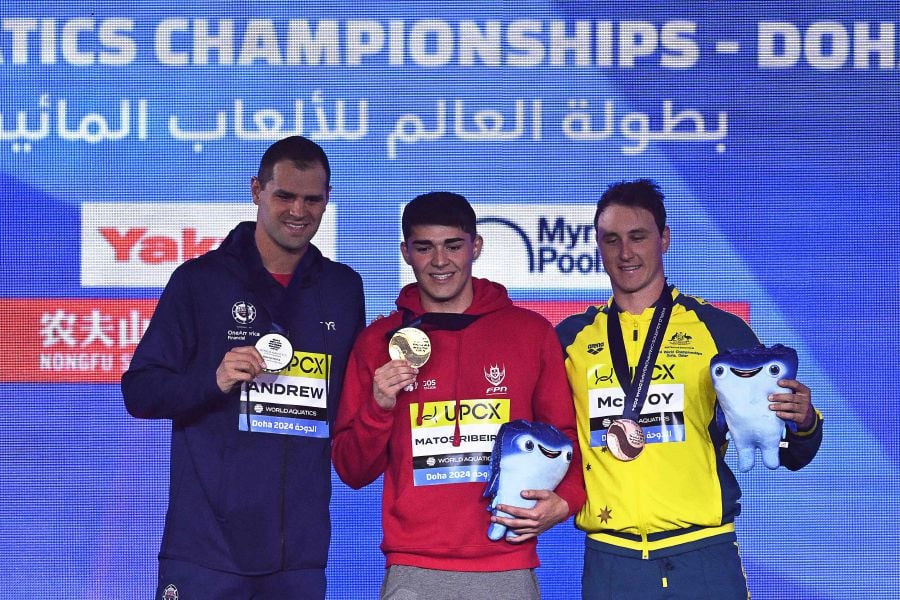 Gold medallist Portugal's Diogo Matos Ribeiro (C), silver medallist US' Michael Andrew (L) and bronze medallist Australia's Cameron Mcevoy pose on the podium of the men's 50m butterfly swimming event during the 2024 World Aquatics Championships at Aspire Dome in Doha on February 12, 2024. - AFP pic