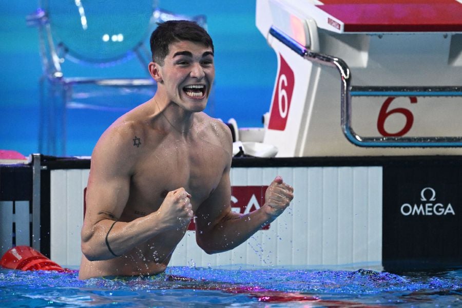 Portugal's Diogo Matos Ribeiro celebrates after winning the final of the men's 50m butterfly swimming event during the 2024 World Aquatics Championships at Aspire Dome in Doha on February 12, 2024. - AFP pic