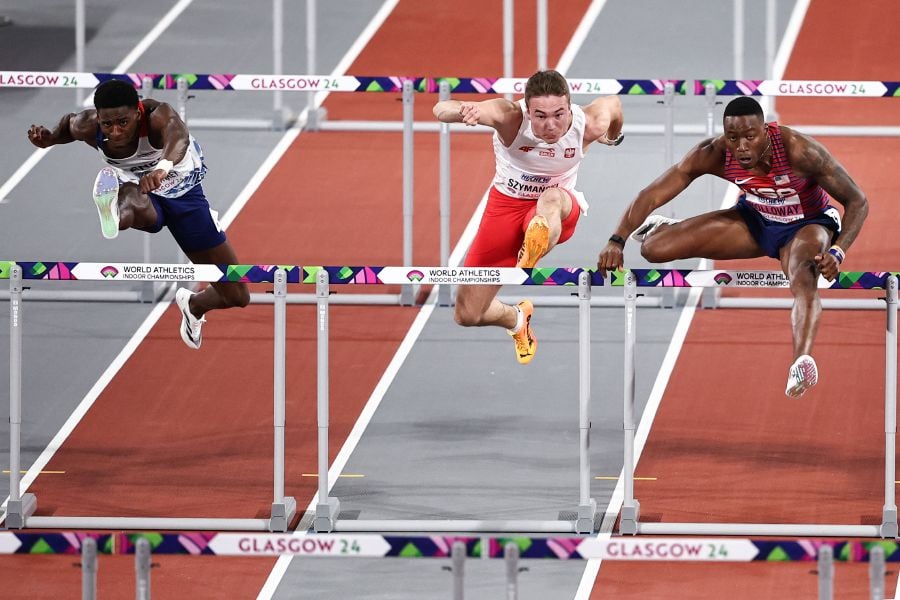 (From L) France's Just Kwaou-Mathey, Poland's Jakub Szymanski and USA's Grant Holloway competes in the Men's 60m hurdles final during the Indoor World Athletics Championships in Glasgow, Scotland, on March 2, 2024. - AFP pic