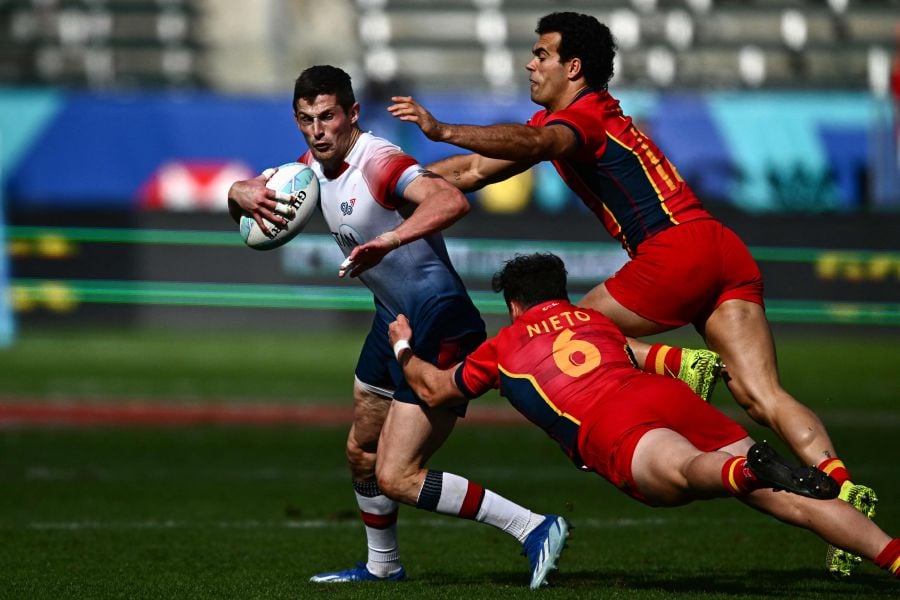 Spain's Eduardo Lopez (R) and Nico Nieto try to stop Great Britain's Robbie Fergusson (L) during the 2024 HSBC Rugby Sevens Los Angeles tournament match between Great Britain and Spain at Dignity Health Sports Park in Carson, California on March 3, 2024. - AFP pic