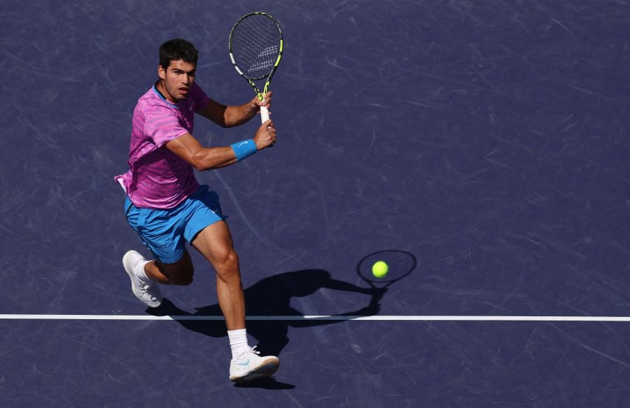 Carlos Alcaraz of Spain plays a backhand volley against Fabian Marozsan of Hungary in their fourth round match during the BNP Paribas Open at Indian Wells Tennis Garden on March 12, 2024. - AFP pic
