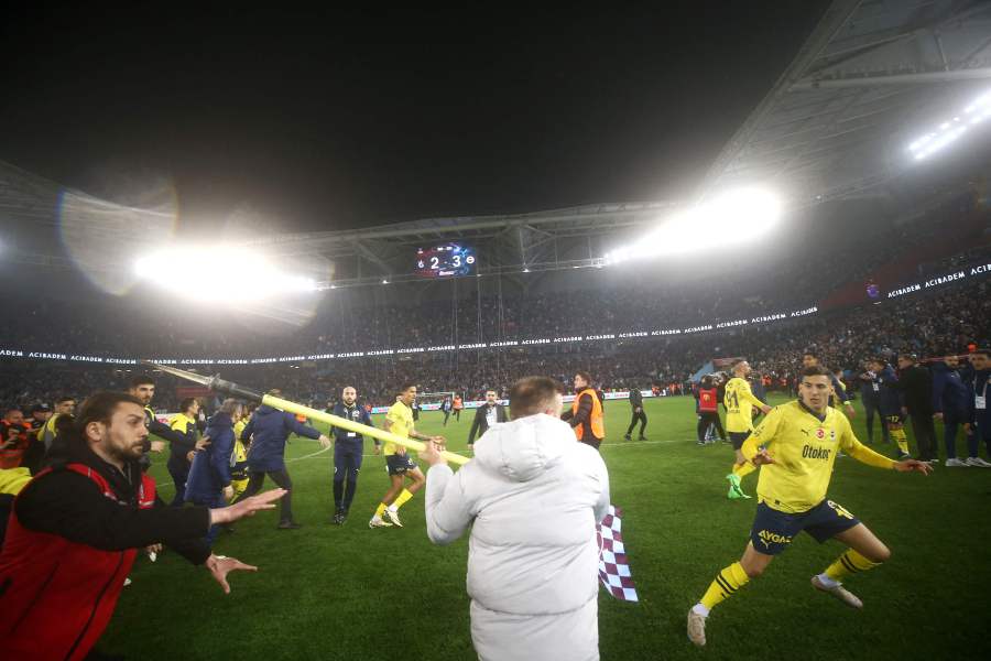 Photo shows Fenerbahce's players being attacked by Trabzonspor supporters during the Turkey Super Lig football match between Trabzonspor and Fenerbahce at the Papara Park. - AFP pic