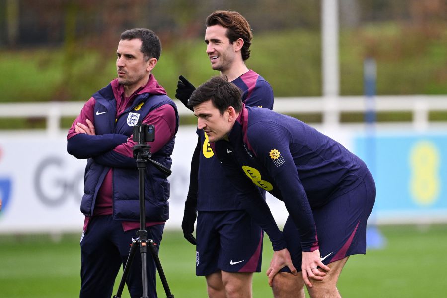 England's defender Harry Maguire (front R) watches a video on a smart phone as part of a team training session at St George's Park in Burton-on-Trent, central England, on March 20, 2024 ahead of their friendly football match against Brasil. - AFP pic