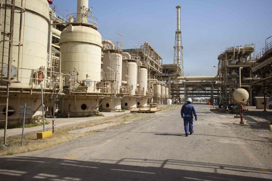 A technician walks in the Rumaylah oil field near Iraq's southern port city of Basra.  - AFP pic