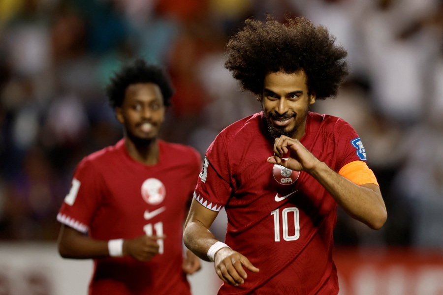 Qatar's midfielder #10 Akram Afif celebrates scoring his team's first goal during the 2026 FIFA World Cup AFC qualifiers football match between Qatar and Kuwait at the Jassim Bin Hamad Stadium in Doha on March 21, 2024. - AFP pic