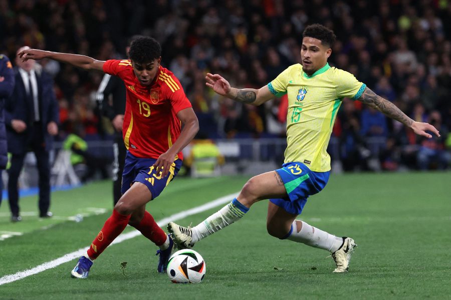Spain's forward #19 Lamine Yamal (L) is is tackled by Brazil's midfielder #15 Joao Gomes during the international friendly football match between Spain and Brazil at the Santiago Bernabeu stadium in Madrid, on March 26, 2024. - AFP pic