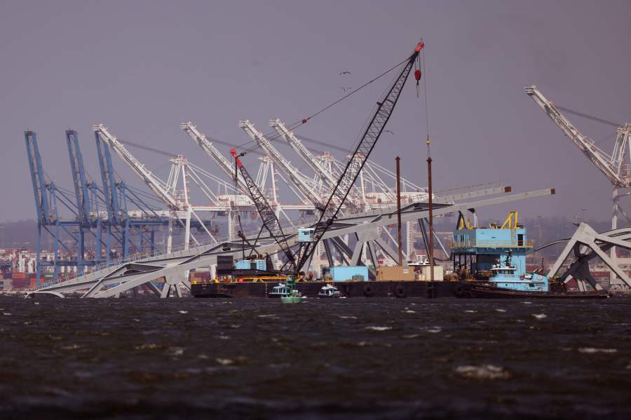 The Port of Baltimore is seen in the background as cranes work on clearing the debris from the Francis Scott Key Bridge on March 29, 2024 in Baltimore, Maryland. - AFP pic